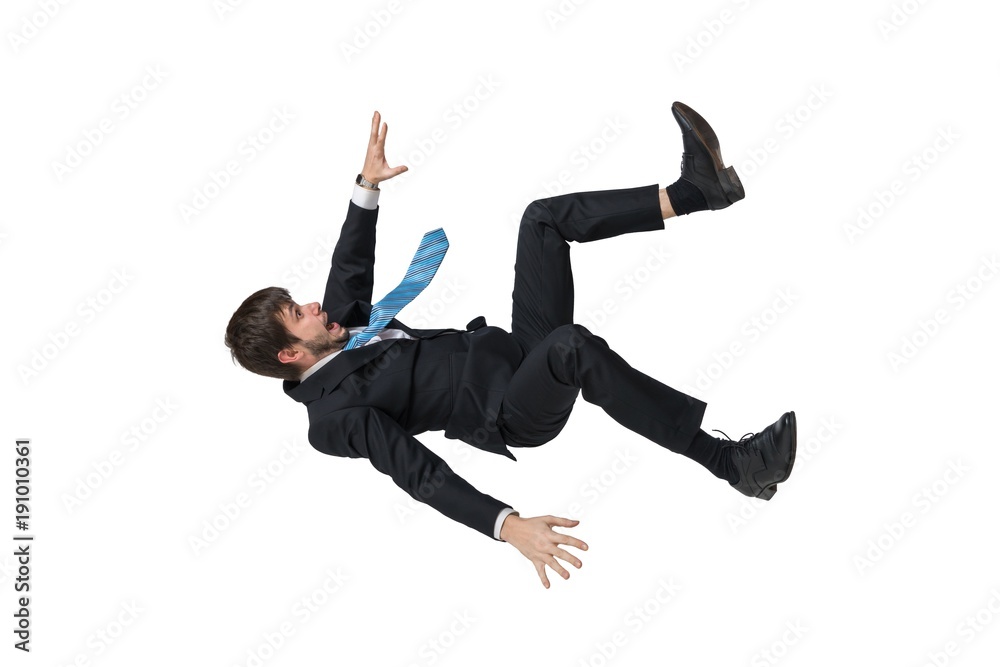 Young businessman falling down in free fall. Isolated on white background. - obrazy, fototapety, plakaty 