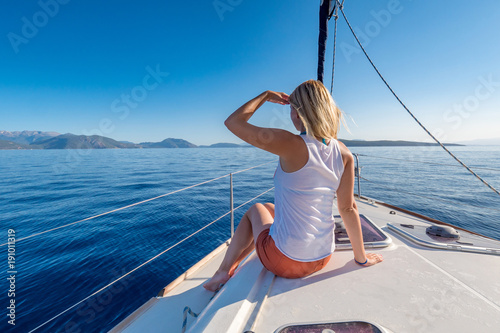 Beautifull young woman on a yacht at sea