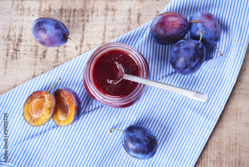 Taty plum jam with spoon on table photo