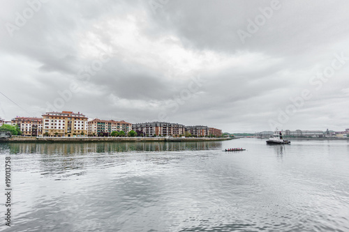 Nervion river with boat rowing photo