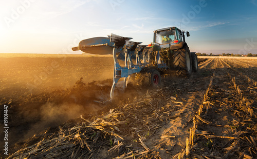 Tractor plowing fields -preparing land for sowing in autumn photo