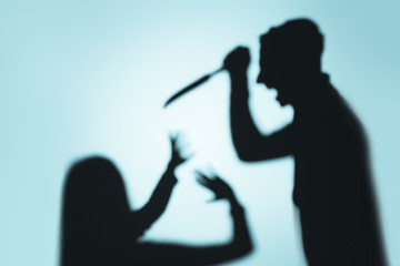 scary blurry shadows of fearful murder on blue