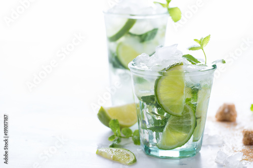 Mojito Cocktail.Mint, lime, ice, cane sugar ingredients for making on a white background.Cold Drink.Top View.Copy space for Text.selective focus.
