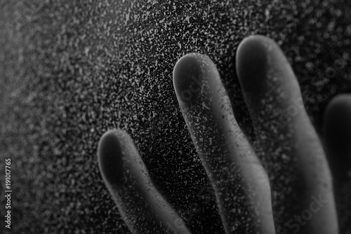 close-up partial view of human hand touching frosted glass photo