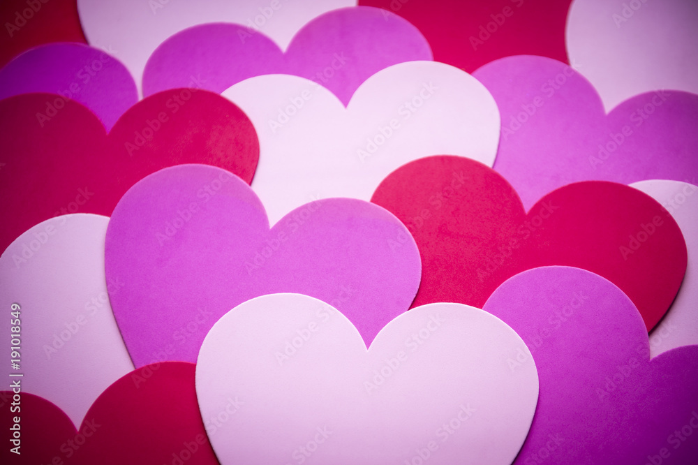 Abstract valentine's background of layered hearts in shades of red, purple and pink