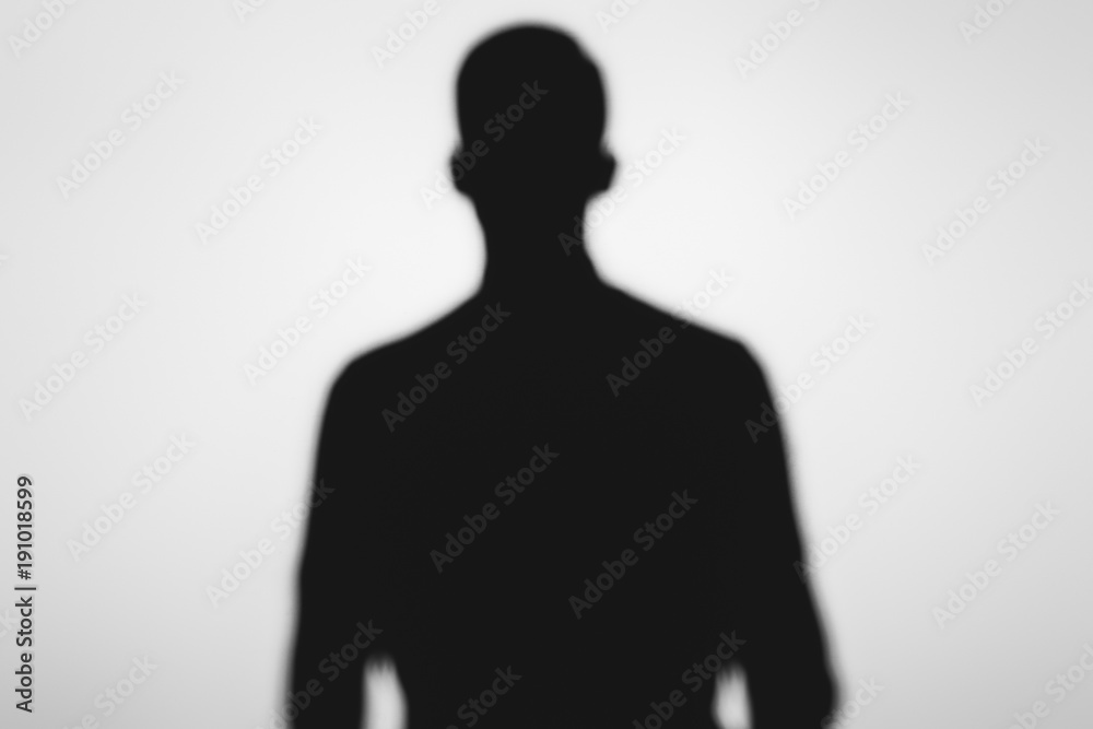 mysterious blurry shadow of spooky person standing on grey mysterious blurry shadow of spooky person standing on grey