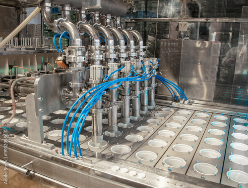 unit for pouring yoghurt into plastic jars at a dairy factory