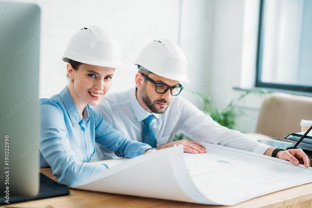 successful architects working with building plan at office successful architects working with building plan at office