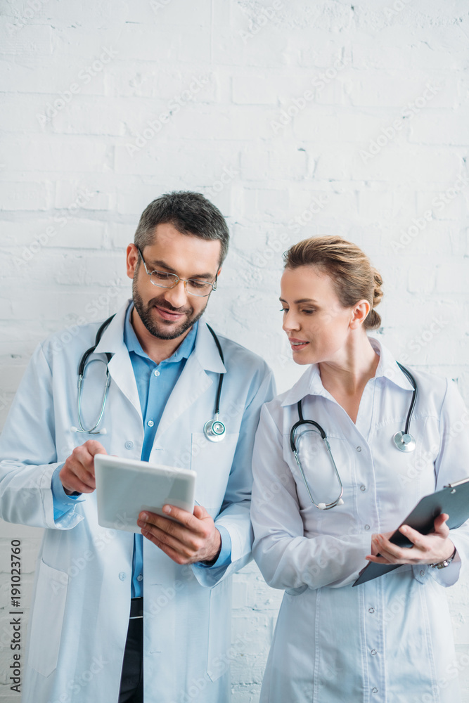 doctors working together with tablet and clipboard doctors working together with tablet and clipboard