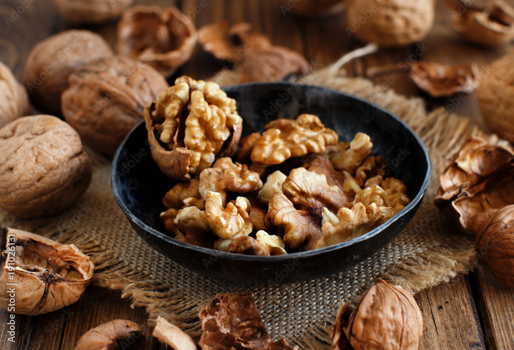 Fresh walnuts on an old wooden table Fresh walnuts on an old wooden table