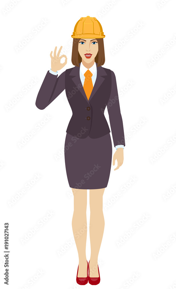 Businesswoman in construction helmet showing a okay hand sign Businesswoman in construction helmet showing a okay hand sign