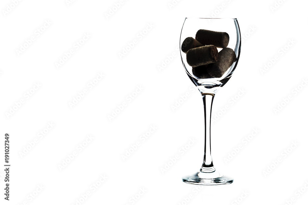 Empty glass of wine with wine stoppers (cork) inside on a white background (isolate).