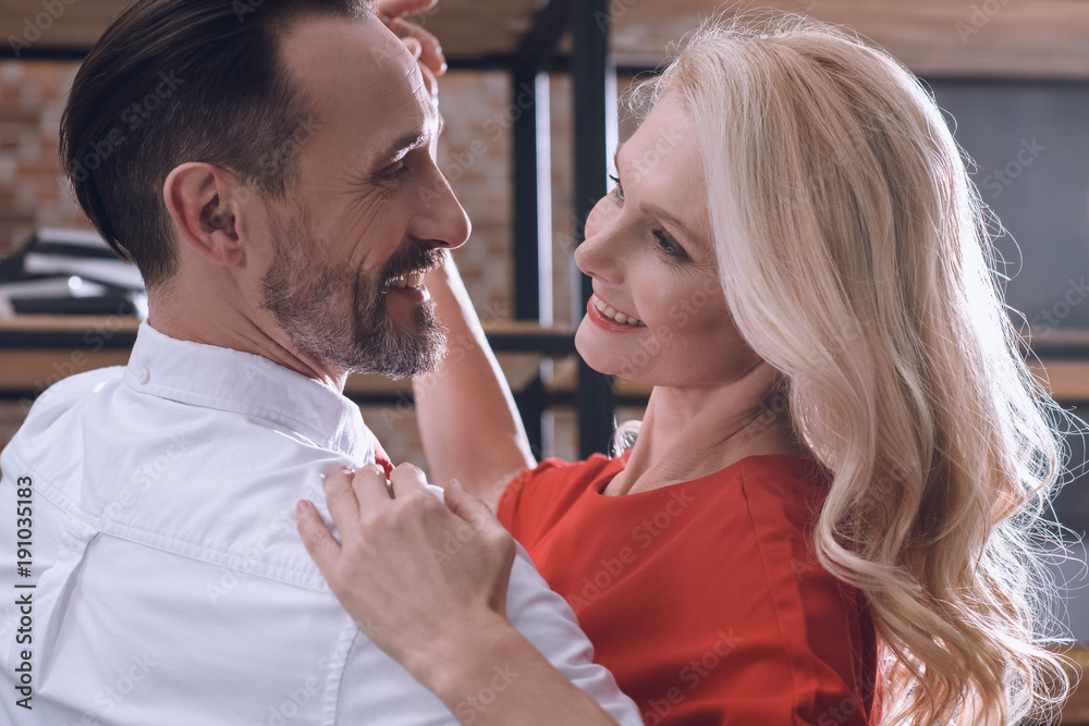 smiling happy heterosexual couple dancing at home at romantic date smiling happy heterosexual couple dancing at home at romantic date