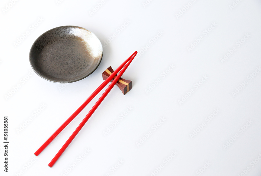 red chopsticks and Ceramic plate White background Copy space red chopsticks and Ceramic plate White background Copy space