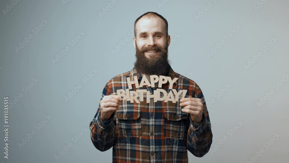 Hipster man dreaming and showing Happy Birthday banner Hipster man dreaming and showing Happy Birthday banner
