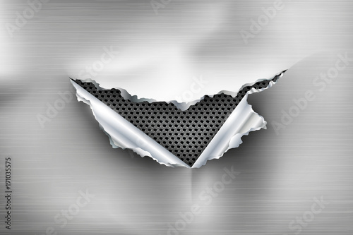 Hole torn in ripped steel on metal background