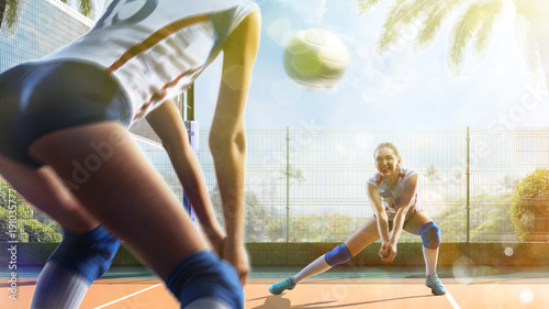 Professional female volleyball players in action on the court