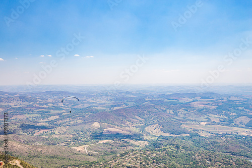 Belo Horizonte, Minas Gerais, Brazil. Paraglider flying from top of the world mountain