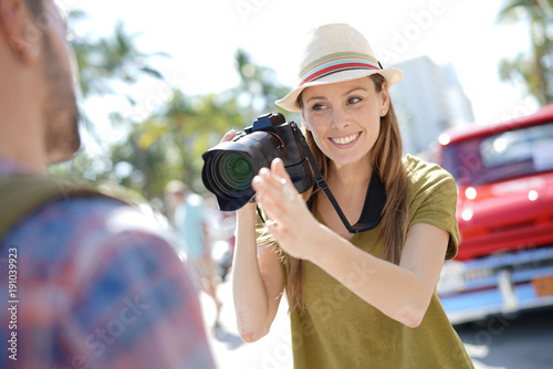 Woman photographer taking picture of model in the street of Miami © goodluz