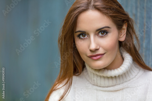 Beautiful Young Woman With Red Hair Wearing a Sweater