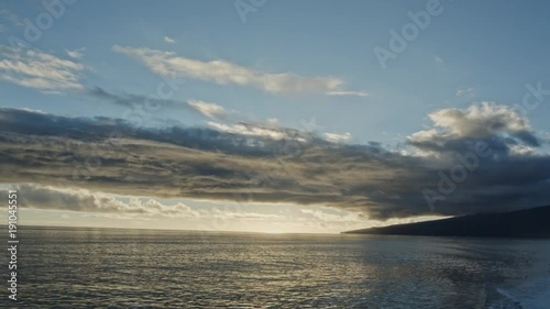 Marvellous vanilly sky over an island and beautiful reflection in the ocean.