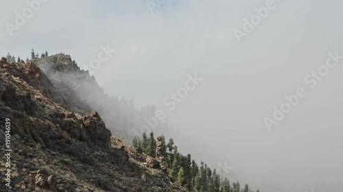 Mist climbing up a mountain.