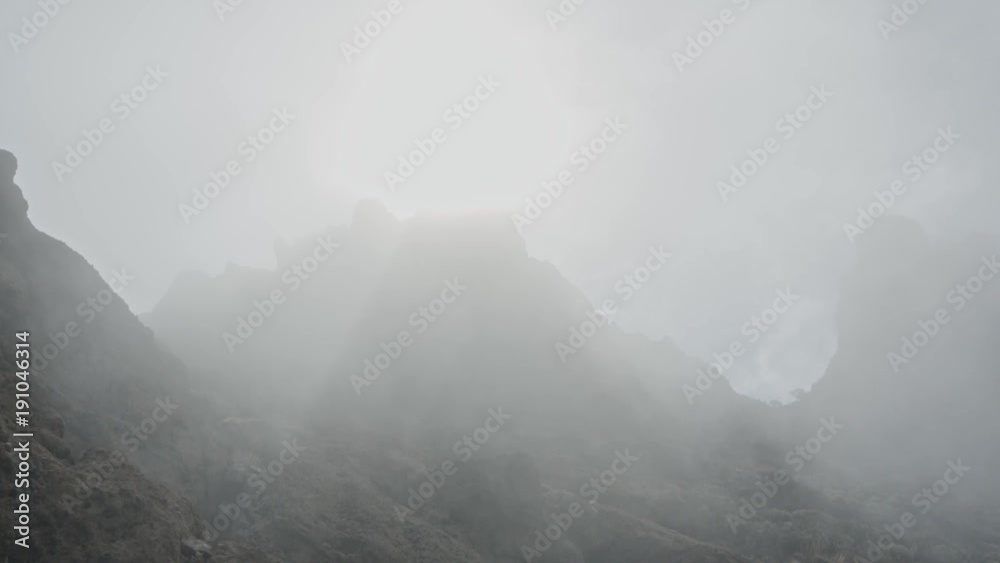 Very foggy cliff with lightrays coming through.