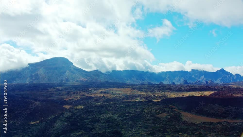 Dramatic time lapse of clouds over mountains.