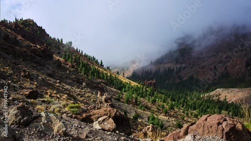 Foggy valley in between mountains.