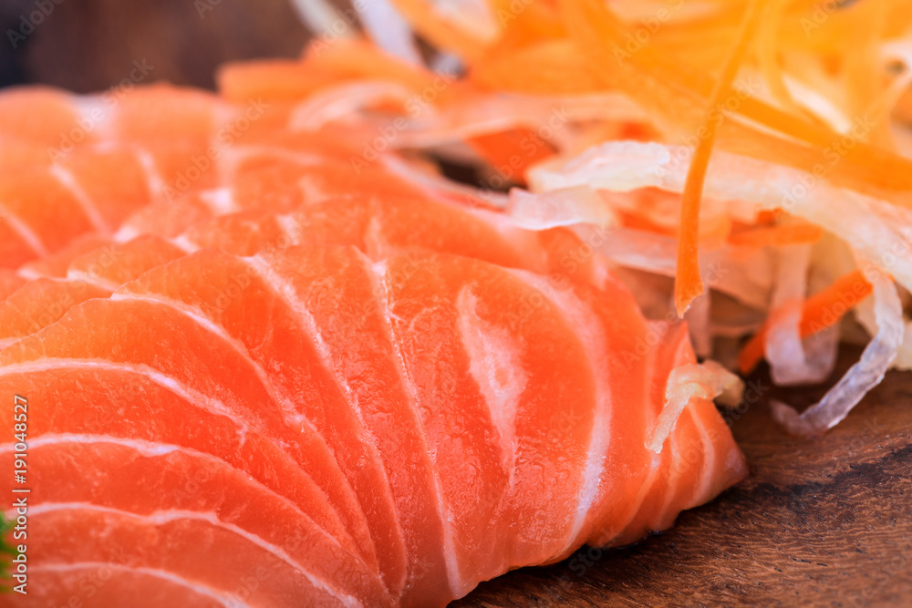 Salmon sashimi in wooden bowl on the table. Salmon sashimi in wooden bowl on the table.