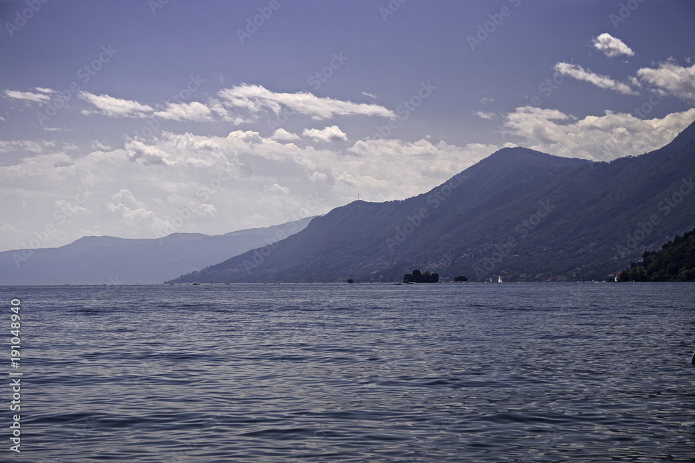 Panoramic view of the lake with a pebble beach in the foreground.