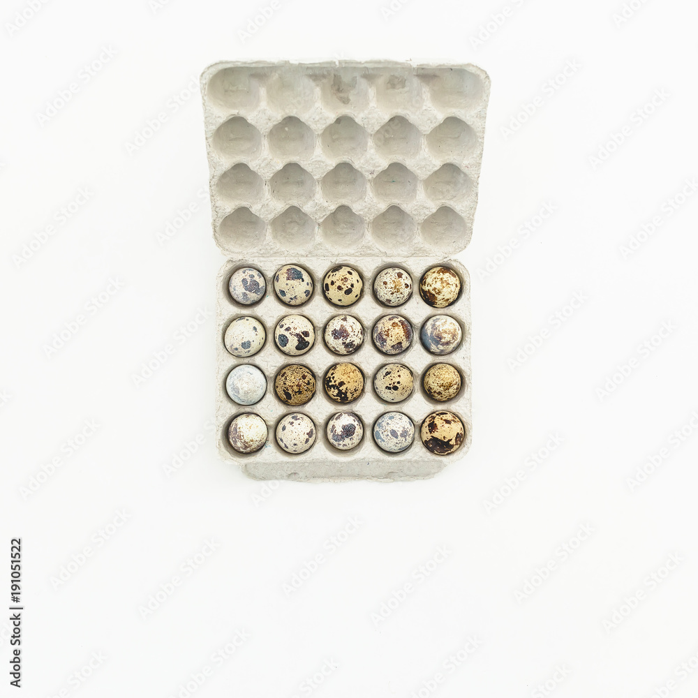 Quail eggs in paper box on white background. Flat lay, top view. Easter concept. Quail eggs in paper box on white background. Flat lay, top view. Easter concept.