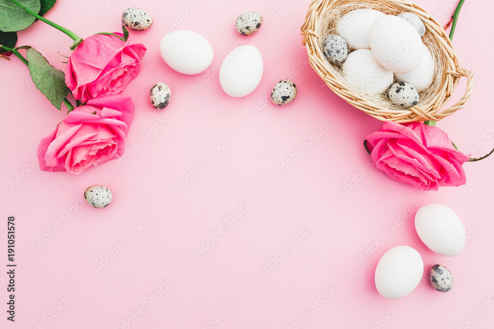 Easter egg and quail eggs in box and roses on pastel pink background, Top view Easter egg and quail eggs in box and roses on pastel pink background, Top view