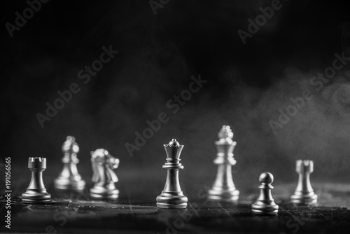 silver chess on world map with smoke background illustrate strategy and business concept