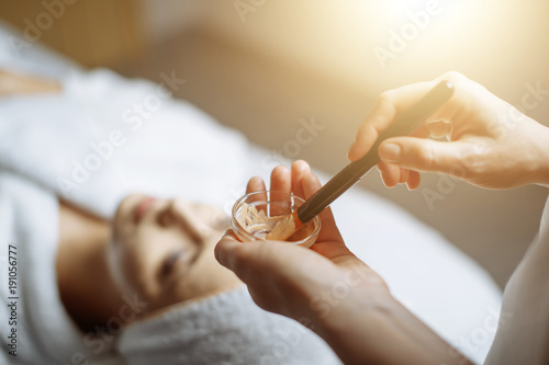 Young woman having mask procedure in spa centre
