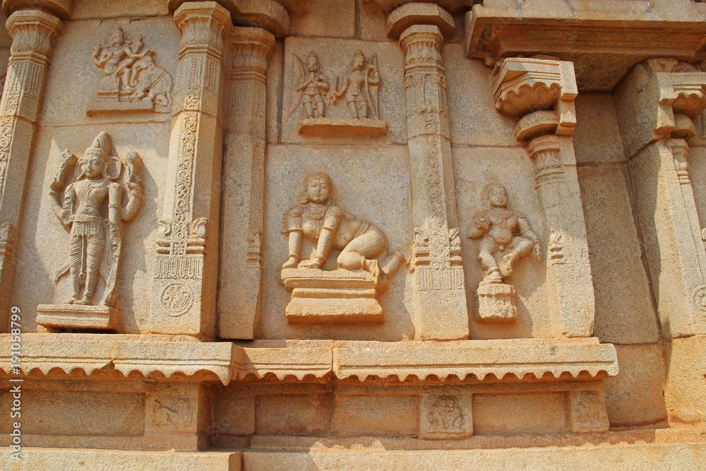 Stone bas-reliefs on the walls around the Vittala Temple in Hampi, Karnataka, India.