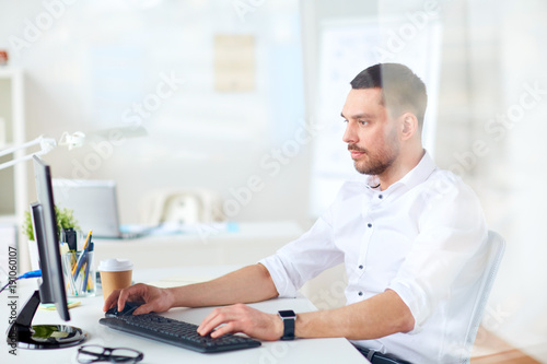 businessman typing on computer keyboard at office
