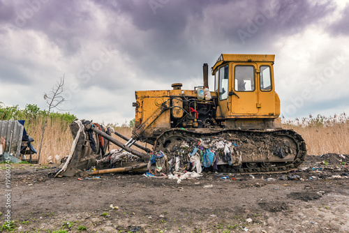yellow bulldozer on the dump