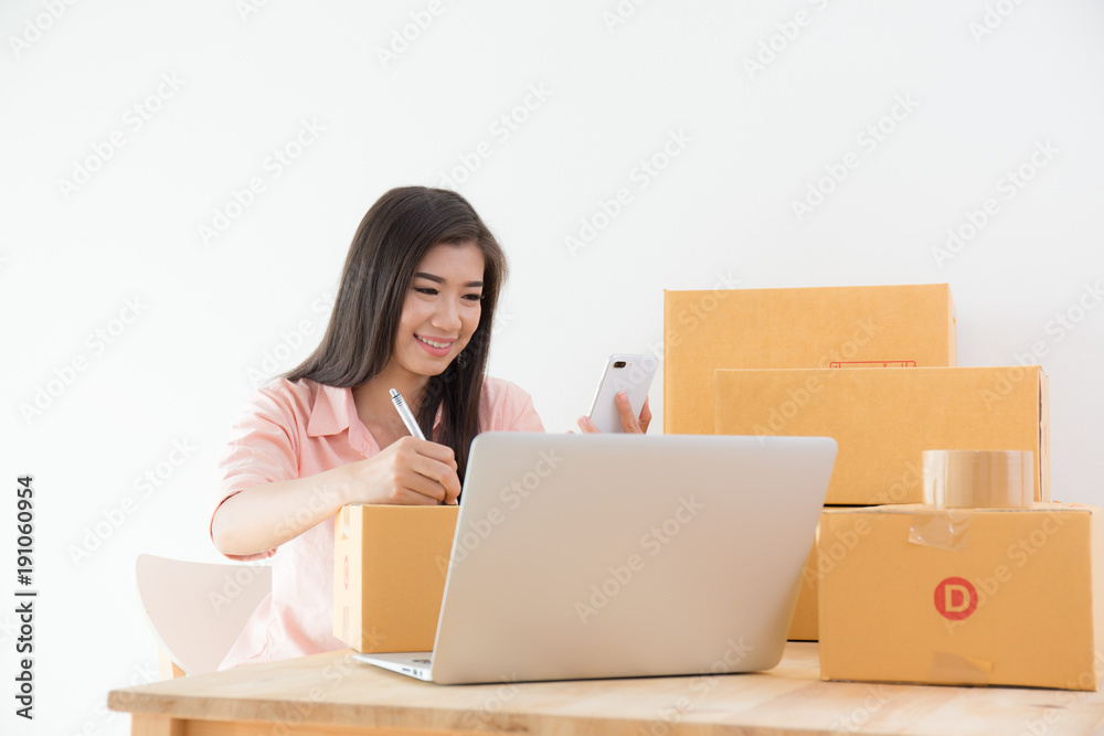 Asian women are smiling and recording customer orders,business online marketing concept
