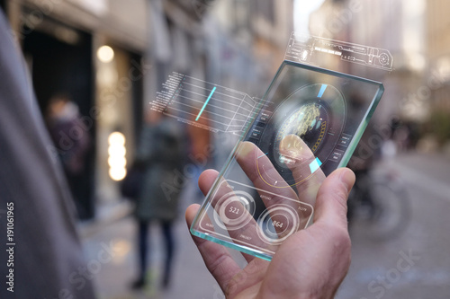 A man in the city, use the transparent phone with the latest technology for video calls with holography family on vacation. Concept: technology, future and futuristic technology, family photo