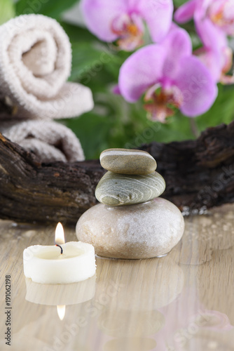 Spa Still Life, Stones, Candle and wood on green background