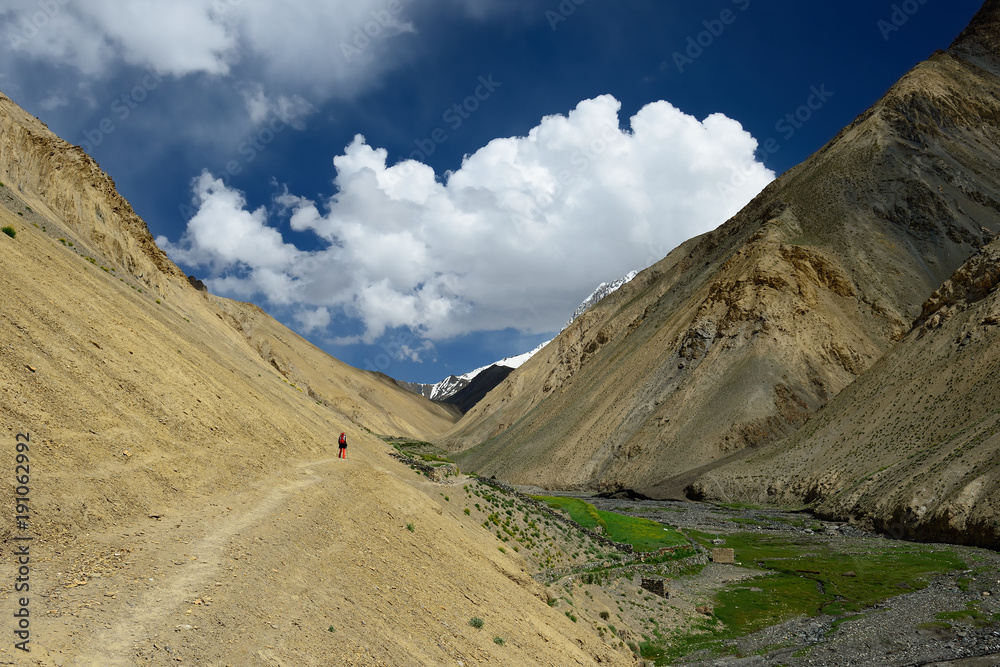 Traveller on the trekking on Markha valley trek route in Ladakh, Karakorum panorama. This region is a purpose of motorcycle expeditions Traveller on the trekking on Markha valley trek route in Ladakh, Karakorum panorama. This region is a purpose of motorcycle expeditions
