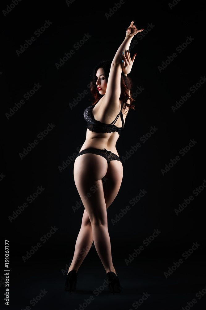 Beautiful sexy woman in lingerie posing on black studio background, low key  studio shot Stock 写真 | Adobe Stock