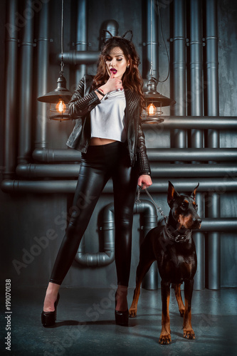brutal young girl and dobermann in the studio

