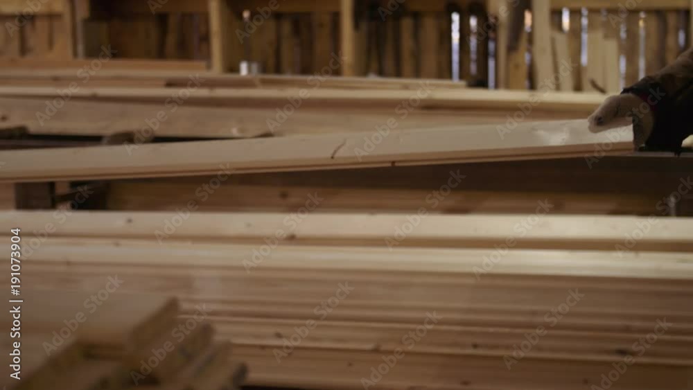 Wood board running out carpenter refiner workbench at sawmill facility, lots of sawdust Wood board running out carpenter refiner workbench at sawmill facility, lots of sawdust