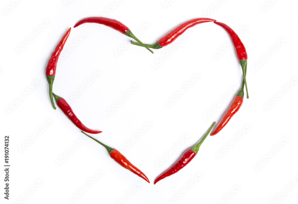 Red chili peppers forming a heart with copy space on white background. Red chili peppers forming a heart with copy space on white background.