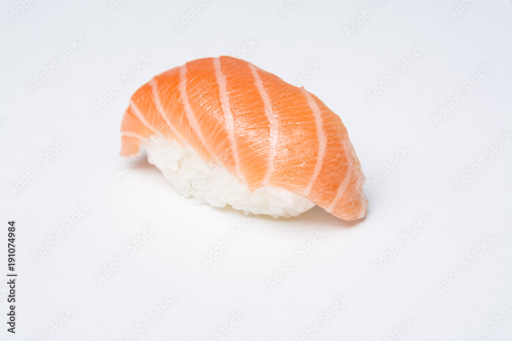 Close-up of traditional japanese sushi nigiri with a slice of raw salmon on white background. Close-up of traditional japanese sushi nigiri with a slice of raw salmon on white background.
