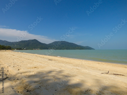 Tropical beach in Teluk bahang with mountains of the National Park in the background - Penang, Malaysia