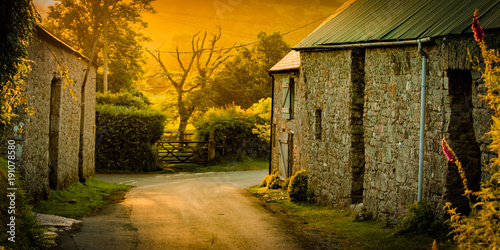 Dawn on english farm with barns and rural road