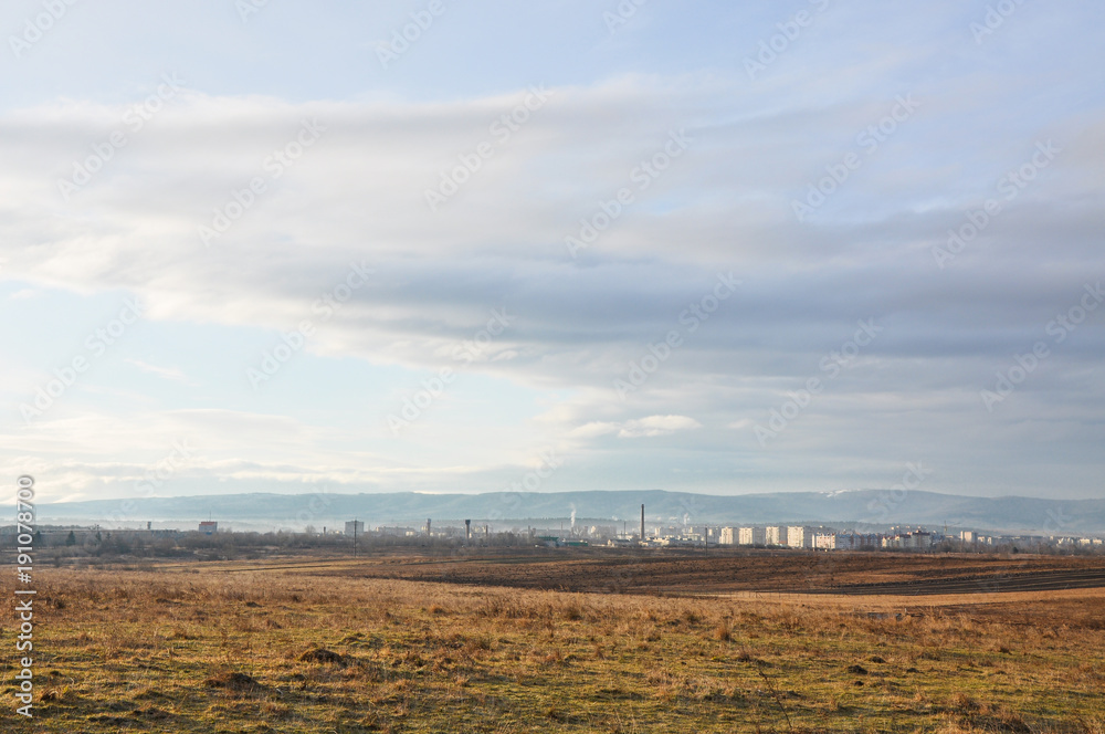 Landscape with look at Drohobych city from afar, Western Ukraine. Residential area and industrial area in the foreground, mountains in the background.